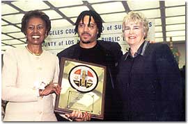 Yvonne B. Burke, Supervisor; Michael Datcher, Honoree; Margaret Donnellan Todd, County Librarian